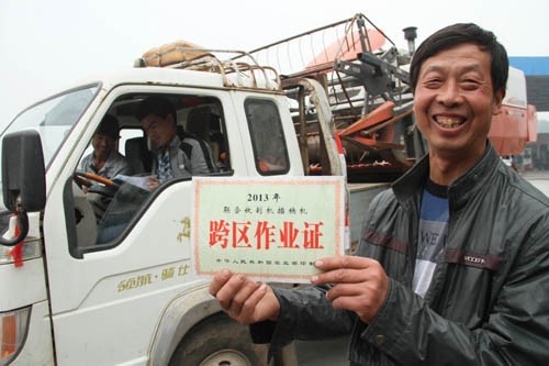河南省焦作市武陟县嘉应观乡东营村农机手荆占通在展示他的跨区作业证。